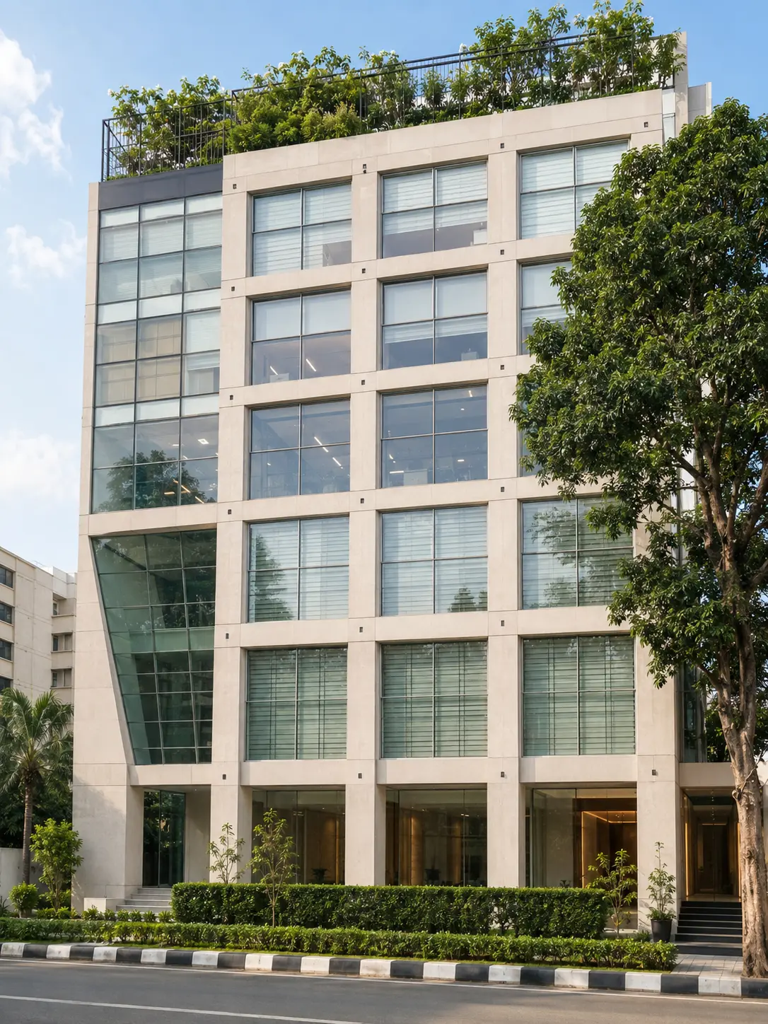 Bond Center street view — stone-framed facade, full-height glazing and landscaped frontage on Road 11, Banani